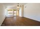 Bright living room with vaulted ceilings, ceiling fan, and sliding glass doors at 15701 N Bonow Dr, Surprise, AZ 85374