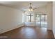 Spacious living room with vaulted ceilings, ceiling fan, and sliding glass doors at 15701 N Bonow Dr, Surprise, AZ 85374