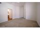 Primary bedroom with carpet, access to ensuite bathroom, and a closet at 15701 N Bonow Dr, Surprise, AZ 85374