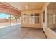 Cozy covered patio connecting the indoors with the backyard at 15701 N Bonow Dr, Surprise, AZ 85374