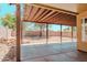 Spacious covered patio with stone landscaping providing a backyard oasis at 15701 N Bonow Dr, Surprise, AZ 85374