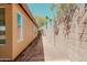 View of the side yard of the home with block wall for privacy at 15701 N Bonow Dr, Surprise, AZ 85374