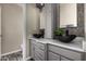 Bathroom featuring dual bowl sinks, granite counters, and gray vanities at 16823 S 24Th Pl, Phoenix, AZ 85048