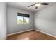 Neutral bedroom with wood floors, ceiling fan, and a window for natural light at 16823 S 24Th Pl, Phoenix, AZ 85048