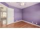 Bedroom featuring wood floors, ceiling fan, and bright purple walls at 16823 S 24Th Pl, Phoenix, AZ 85048