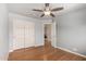 Bright bedroom with wood floors, ceiling fan, and closet at 16823 S 24Th Pl, Phoenix, AZ 85048