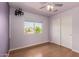 Bedroom featuring wood floors, closet, window, and ceiling fan at 16823 S 24Th Pl, Phoenix, AZ 85048