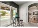 Stylish dining area with a bar-height table overlooking the pool and backyard at 16823 S 24Th Pl, Phoenix, AZ 85048