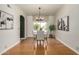 Dining room features hardwood floors, chandelier, and a view of the outdoor greenery at 16823 S 24Th Pl, Phoenix, AZ 85048
