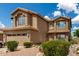 Two-story home featuring a tile roof, desert landscaping, and an attached two-car garage at 16823 S 24Th Pl, Phoenix, AZ 85048