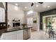 Bright kitchen featuring white cabinets, granite countertops, and an open layout to the living area at 16823 S 24Th Pl, Phoenix, AZ 85048