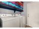 Well-equipped laundry room with a washer, dryer, and shelving for storage at 16823 S 24Th Pl, Phoenix, AZ 85048
