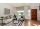 Bright living room with wooden floors, natural light from large windows, and modern décor at 16823 S 24Th Pl, Phoenix, AZ 85048