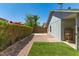 Landscaped backyard with artificial turf, gravel, and a concrete patio near a block fence at 18219 N 19Th St, Phoenix, AZ 85022