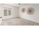 Minimalist bedroom design features clean white walls, neutral carpet, and a window for abundant natural light at 18219 N 19Th St, Phoenix, AZ 85022