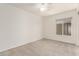 Clean and bright bedroom space features neutral carpet, a large window, and a ceiling fan at 18219 N 19Th St, Phoenix, AZ 85022