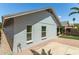 View of the home's rear exterior, showcasing the backyard with desert landscaping and a patio at 18219 N 19Th St, Phoenix, AZ 85022