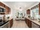 Bright kitchen boasts updated appliances, granite counters, and a cozy seating area with neighborhood views at 18219 N 19Th St, Phoenix, AZ 85022