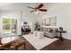 Bright living room with vaulted ceilings, ceiling fan, stylish furnishings, and access to the backyard at 18219 N 19Th St, Phoenix, AZ 85022