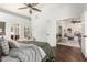 Spacious main bedroom featuring wood flooring, neutral colors, ceiling fan, and ample natural light at 18219 N 19Th St, Phoenix, AZ 85022