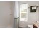 Bright bathroom featuring a clean white shower stall with white and green curtain and a window at 18219 N 19Th St, Phoenix, AZ 85022
