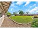 Large, grassy backyard with gravel border, pool, and mature landscaping at 18428 N 42Nd St, Phoenix, AZ 85032