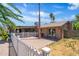 Charming backyard featuring a brick patio, white picket fence, and mature trees at 18428 N 42Nd St, Phoenix, AZ 85032