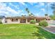 Beautiful backyard with lush green lawn, sparkling pool, and mature landscaping at 18428 N 42Nd St, Phoenix, AZ 85032