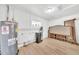 Basement area with laminate flooring, white brick walls, and utility appliances at 18428 N 42Nd St, Phoenix, AZ 85032