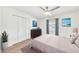 Tastefully decorated bedroom featuring light wood floors, a ceiling fan, and pool views at 18428 N 42Nd St, Phoenix, AZ 85032