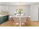 Bright dining room features a light wood table with seating for six and a modern light fixture at 18428 N 42Nd St, Phoenix, AZ 85032