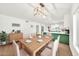 Elegant dining area with modern lighting, laminate floors, and a view of the updated island kitchen at 18428 N 42Nd St, Phoenix, AZ 85032