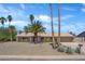 Charming single-story home with desert landscaping and tall palm trees in a sunny neighborhood at 18428 N 42Nd St, Phoenix, AZ 85032