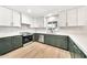 Bright, updated kitchen featuring white and green cabinets, stainless steel appliances, and laminate floors at 18428 N 42Nd St, Phoenix, AZ 85032