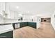 Bright, open kitchen with stainless steel appliances, updated lighting, and green lower cabinets at 18428 N 42Nd St, Phoenix, AZ 85032