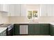 Modern kitchen with stainless steel appliances, stylish green cabinetry, and white countertops, sunny window at 18428 N 42Nd St, Phoenix, AZ 85032