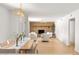 Open-concept living room with a brick fireplace, wood floors, and a dining area at 18428 N 42Nd St, Phoenix, AZ 85032