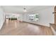 Bright living room with light wood floors, large window, and white walls at 18428 N 42Nd St, Phoenix, AZ 85032