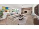 Staged living room featuring a fireplace, large window, and comfortable seating at 18428 N 42Nd St, Phoenix, AZ 85032