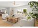 Bright and airy living room with hardwood floors, white couches, and large windows at 18428 N 42Nd St, Phoenix, AZ 85032