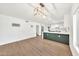 Modern space with stylish laminate flooring, an updated chandelier, and a beautiful island kitchen at 18428 N 42Nd St, Phoenix, AZ 85032