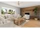 Cozy living room showcasing a brick fireplace, large windows, and comfortable seating at 18428 N 42Nd St, Phoenix, AZ 85032
