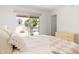 Serene bedroom with patio access, soft bedding, and a view of the backyard at 18428 N 42Nd St, Phoenix, AZ 85032