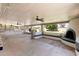 Large covered patio featuring ceiling fans, a fireplace, and ample space for outdoor entertaining at 18428 N 42Nd St, Phoenix, AZ 85032
