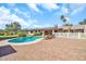 Landscaped backyard featuring a private pool, spacious patio, and comfortable lounge chairs at 18428 N 42Nd St, Phoenix, AZ 85032