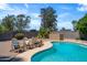 Beautiful backyard with a refreshing pool, comfortable wooden chairs, and well-maintained brick patio at 18428 N 42Nd St, Phoenix, AZ 85032