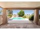 Inviting backyard featuring a sparkling pool, lush landscaping, and comfortable lounge chairs, ideal for relaxation at 18428 N 42Nd St, Phoenix, AZ 85032