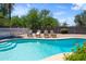Inviting pool area with comfortable seating, a sparkling pool, and well-maintained landscaping perfect for outdoor leisure at 18428 N 42Nd St, Phoenix, AZ 85032