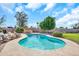 Backyard pool area surrounded by lush landscaping, chairs, and blue skies at 18428 N 42Nd St, Phoenix, AZ 85032