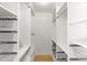Spacious walk-in closet with ample shelving, hanging rods, and metal storage baskets at 18428 N 42Nd St, Phoenix, AZ 85032